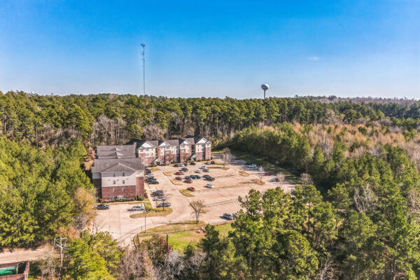 Aerial view of The Overlook student apartment buildings surrounded by East Texas pine forest