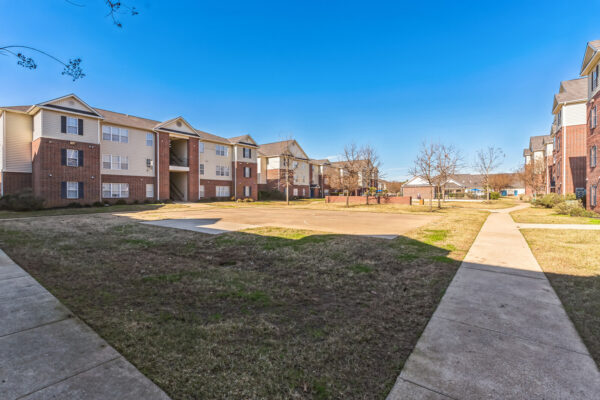 Outdoor basketball court and walkways between apartment buildings at The Overlook Nacogdoches TX