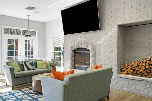 Clubhouse lounge with fireplace and flat screen TV at The Overlook student apartments near SFA