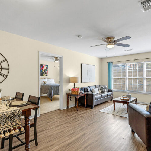 Open-plan furnished living and dining room in a student apartment at The Overlook Nacogdoches TX
