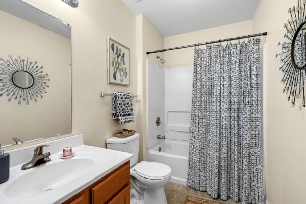 Private bathroom with vanity and shower in a student apartment at The Overlook Nacogdoches TX