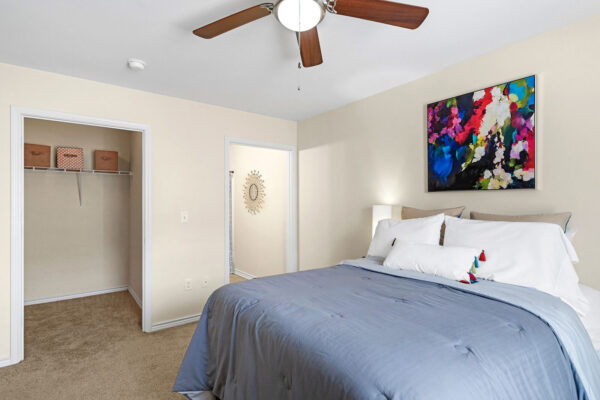 Furnished bedroom with walk-in closet in a student apartment at The Overlook Nacogdoches TX