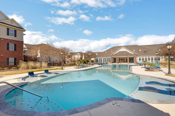 Resort-style swimming pool with lounge chairs at The Overlook student apartments in Nacogdoches TX