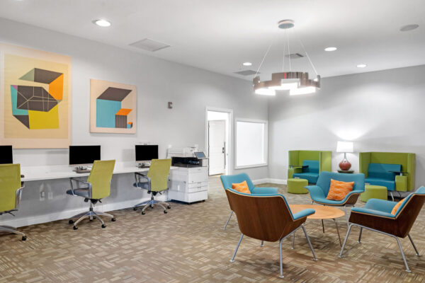 Cyber lounge and study area with computers and seating at The Overlook student apartments near SFA