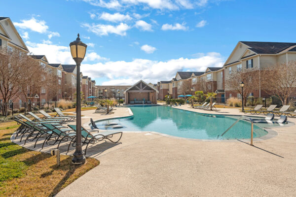 Resort-style swimming pool with lounge chairs and covered pavilion at The Overlook Nacogdoches TX