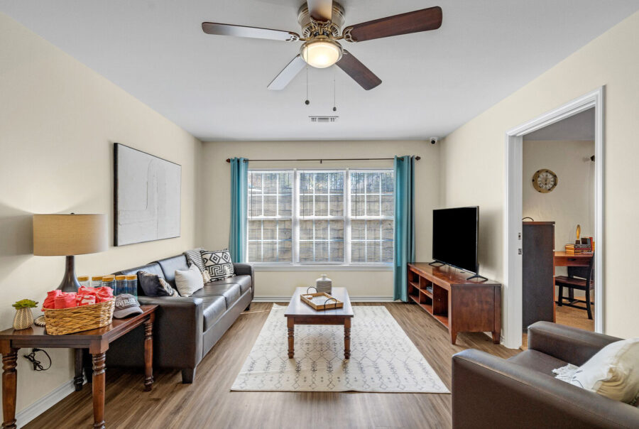 Furnished living room with wood-style flooring in a student apartment at The Overlook Nacogdoches